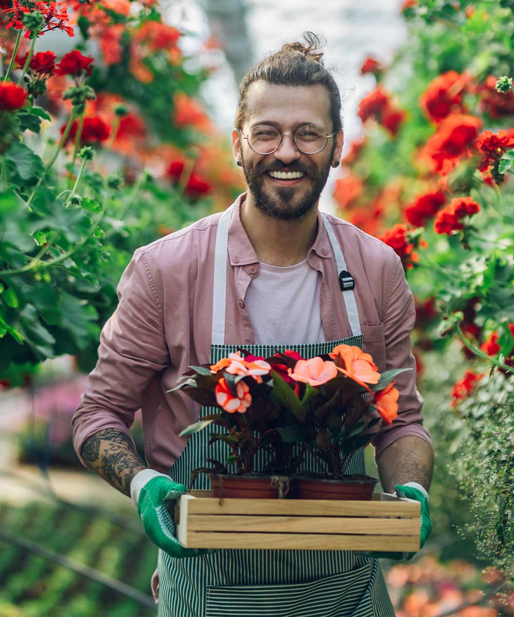 Professional landscaper evaluating plants at a nursery in North Port